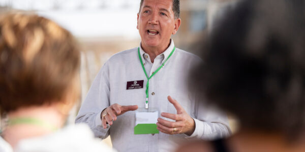 man presenting a course to a group of teachers