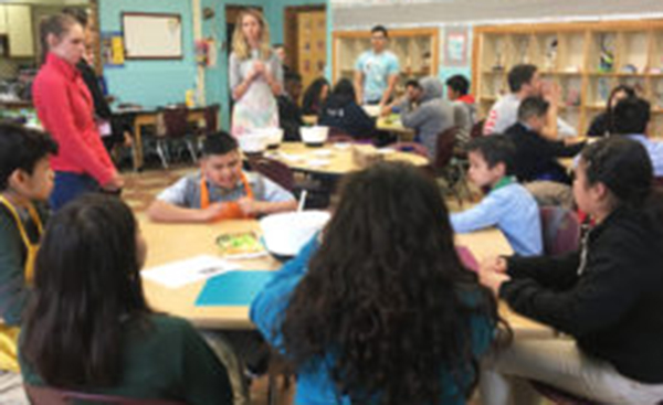 UIC clinical instructor Lindsey Strieter talks to a group of Altus Academy students during a lesson on breakfast in the UIC Health and Wellness Academy