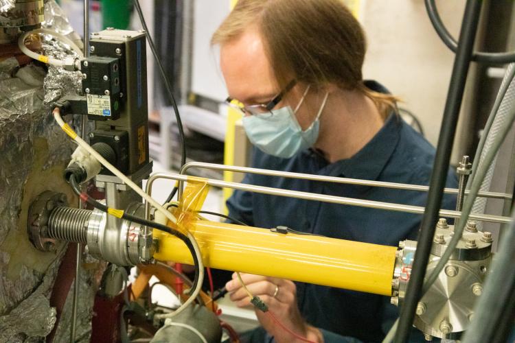 Steve checking connections on the positron accumulator