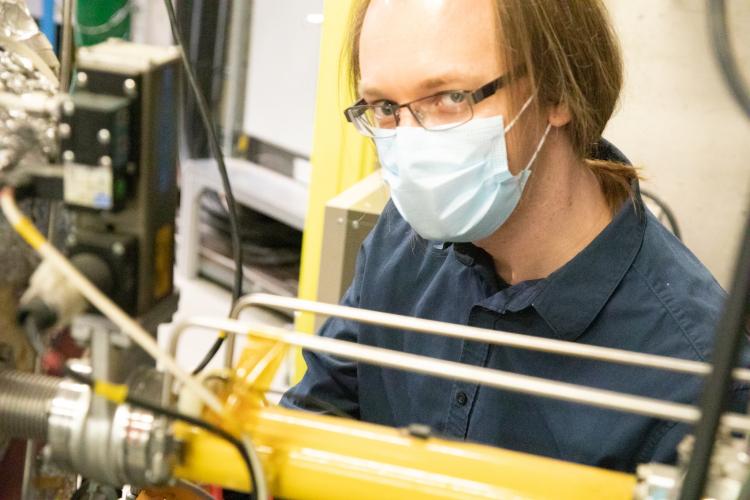 Steve checking connections on the positron accumulator