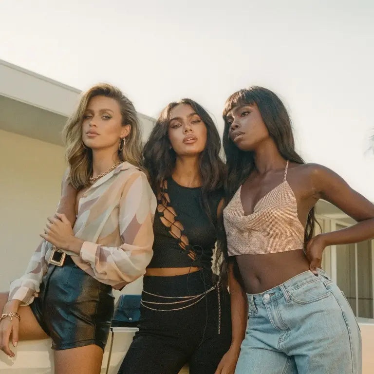 Three women in Princess Polly clothing modelling outdoors