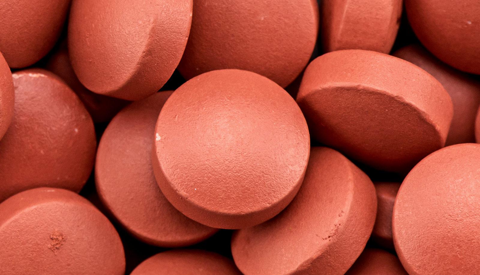 A bunch of red ibuprofen pills