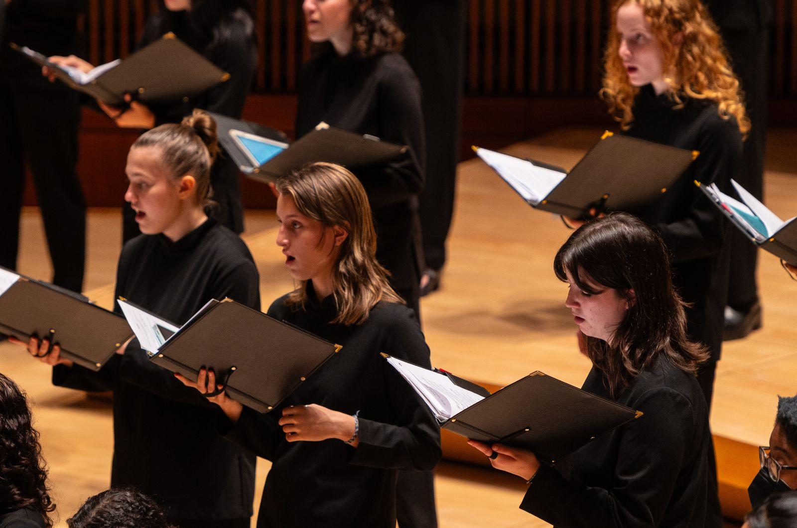 Choral students sing together during a performance.