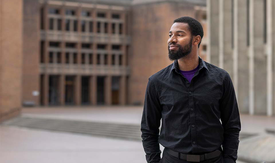 Student standing outside of UW building