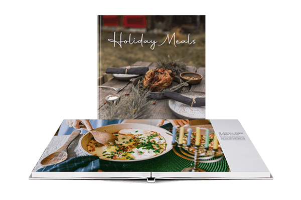 Layflat cookbook opened up to show a picture of a meal during the holidays 