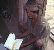 Research paper thumbnail of Ratna examines a book