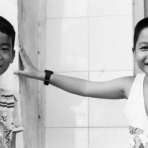 Boys standing talking by roadside