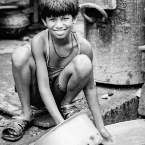 Boy scrubbing pans