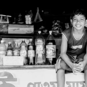 Boy sitting beside plastic bottles