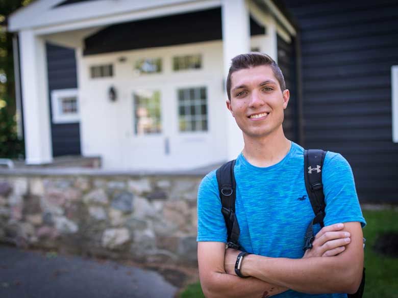 A male student stands outside the Studio Theatre, Mary Behrend's former painting studio.