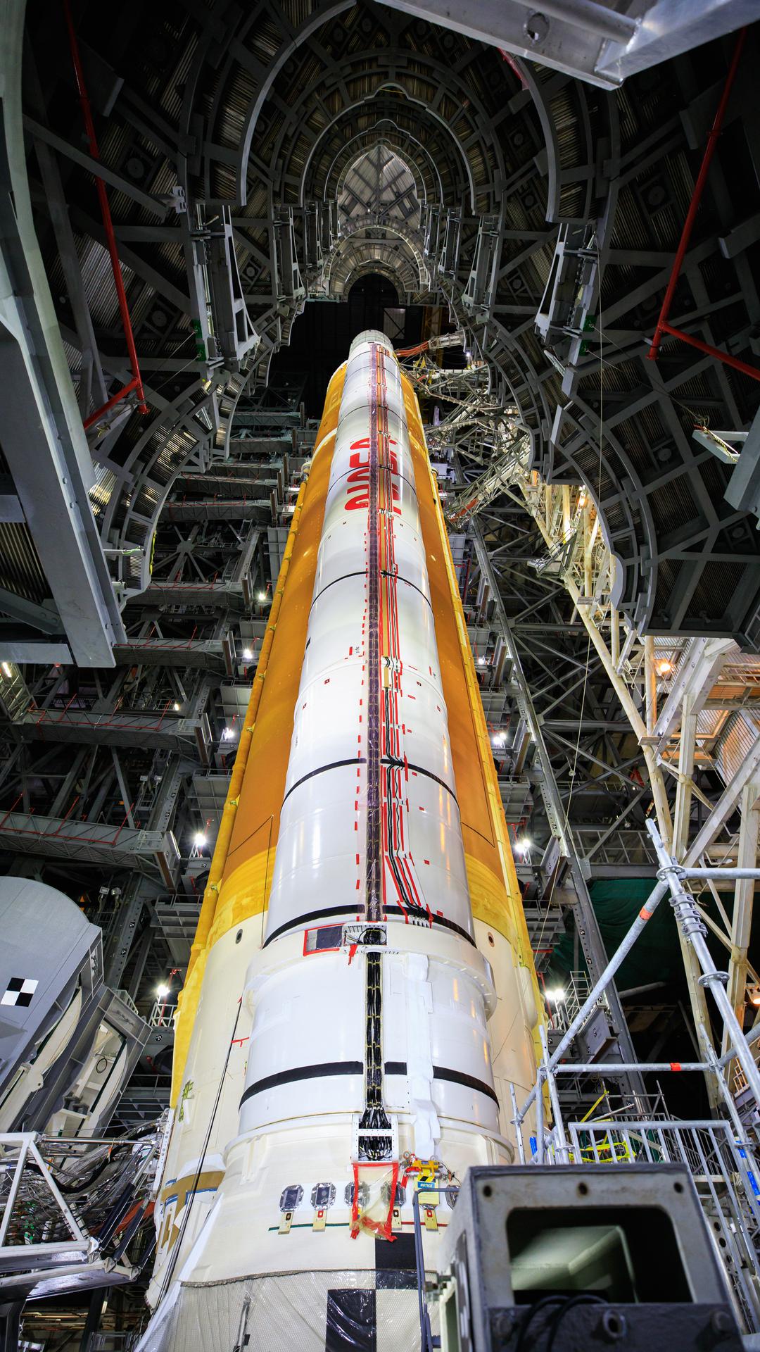 Inside High Bay 3 of the Vehicle Assembly Building at NASA’s Kennedy Space Center in Florida, the work platforms have been retracted from around the Artemis I Space Launch System on Sept. 20, 2021. All 10 levels of platforms were extended and retracted as part of an umbilical test. During the test, several umbilical arms on the mobile launcher were extended to connect to the SLS rocket. They swung away from the launch vehicle, just as they will on launch day. NASA and Jacobs teams will continue conducting tests inside the VAB before transporting the Orion spacecraft to the assembly building and stacking it atop the SLS, completing assembly of the rocket for the Artemis I mission. Artemis I will be the first integrated test of the SLS and Orion spacecraft. In later missions, NASA will land the first woman and the first person of color on the surface of the Moon, paving the way for a long-term lunar presence and serving as a steppingstone on the way to Mars.