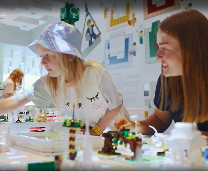 A person and a child playing with lego blocks