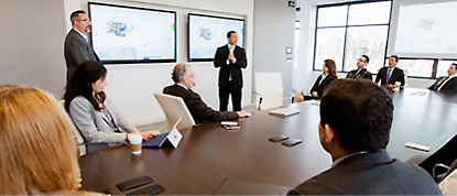 A group of business people sitting around a conference table.