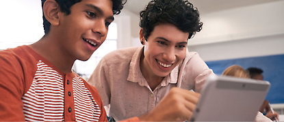 Two students are looking at a tablet.