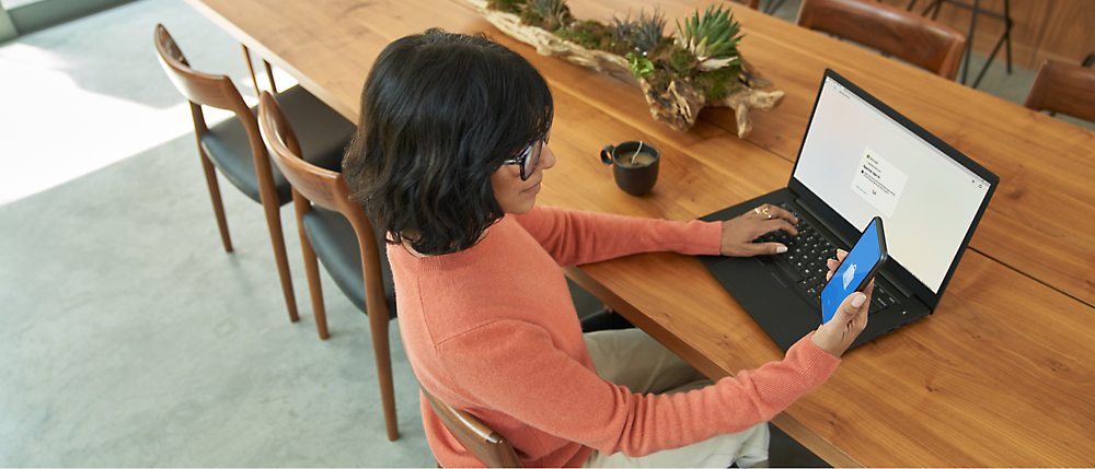 A person sitting at a table using a computer