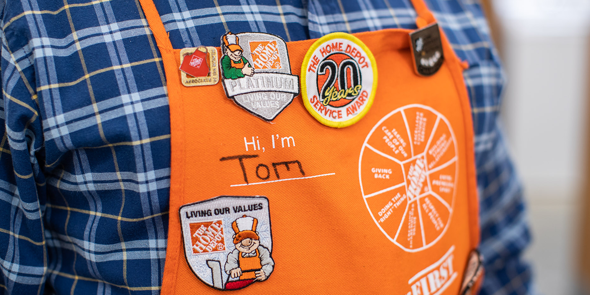 Close up of man's apron adorned with pins