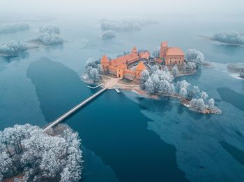 Aerial view of buildings amidst frozen lake