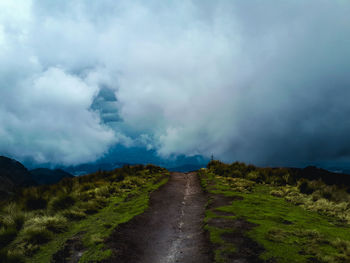 Scenic view of road amidst land against sky