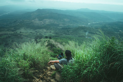 High angle view of men sitting on mountain