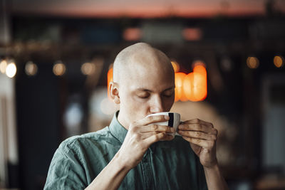 Male cafe owner drinking coffee