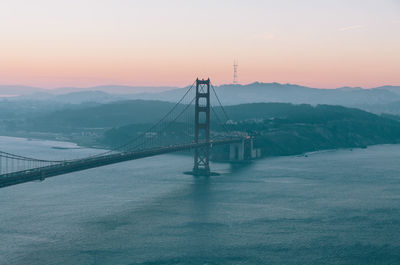 Golden gate bridge over san francisco bay against clear sky during sunrise