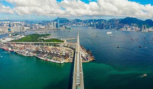 High angle view of cityscape by sea against sky