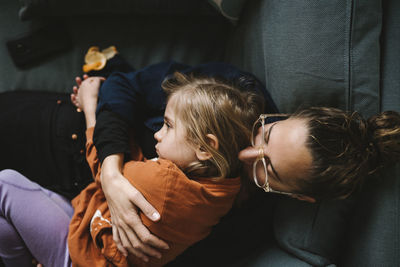 Mother hugging daughter