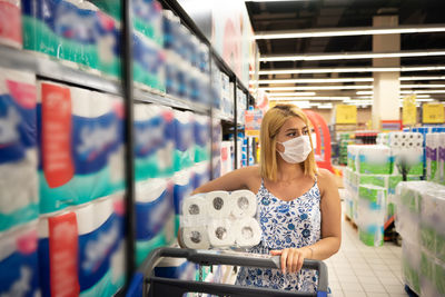 Portrait of young woman standing in store