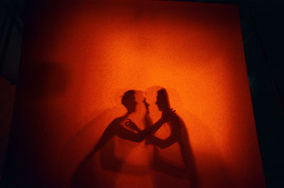 Lovers shadows at orange background