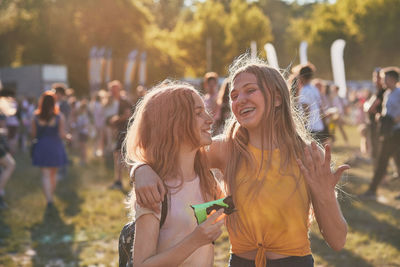 Cheerful teenage friends enjoying holi at park