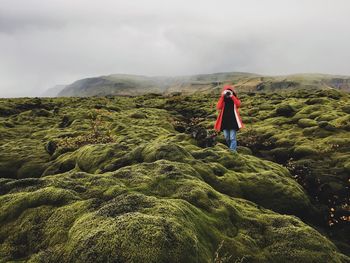 Front view of woman standing on hill