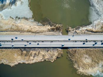 Directly above shot of vehicles on bridge over lake