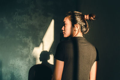 Woman standing against wall