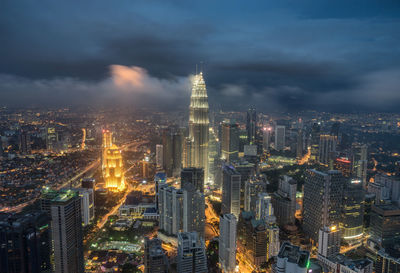 High angle view of city lit up at night