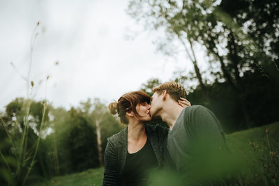 Couple kissing in park