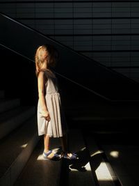 Full length side view of girl standing on steps