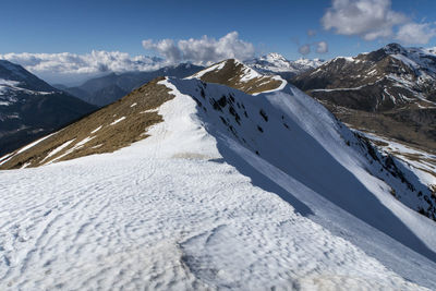 Scenic view of snow covered mountains against sky