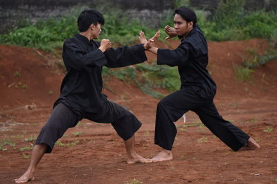 Young men practicing karate outdoors