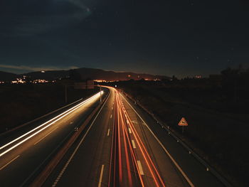 High angle view of light trails on highway at night