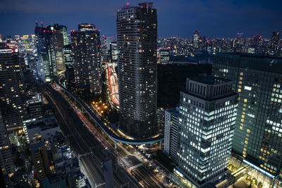 Aerial view of illuminated buildings in city at night