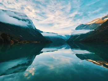 Scenic view of lake and mountains against sky