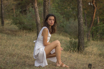 Portrait of beautiful young woman in forest