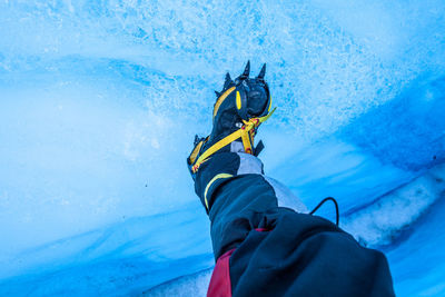 Low section of person standing on ice