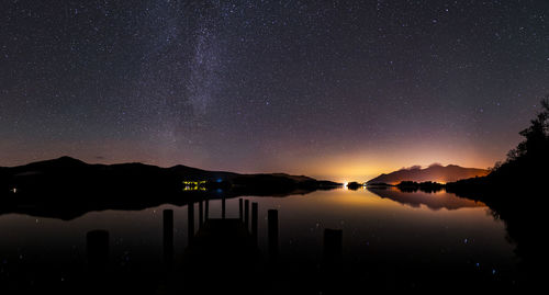 Scenic view of lake against sky at night