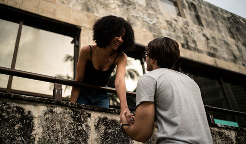 Friends standing against wall