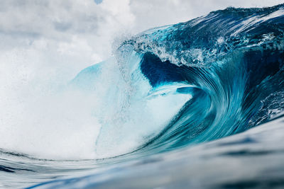 Water splashing in sea against sky