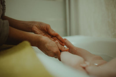 Close-up of woman bathing baby