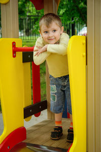 Portrait of happy boy playing on playground