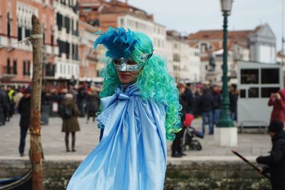 Woman wearing mask and costume during carnival in city