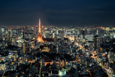 High angle view of city lit up at night